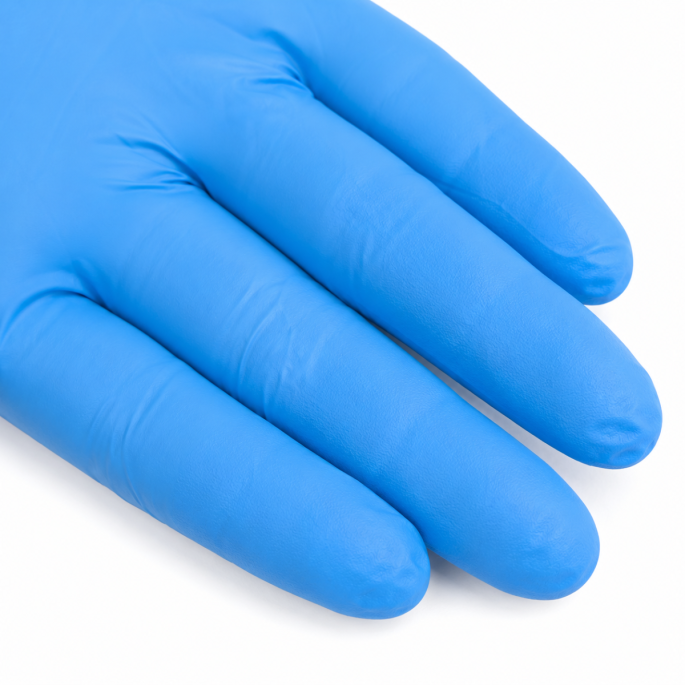 Sterk ingezoomde detailopname van een blauwe disposable nitrilhandschoen. De afbeelding toont de fijne oppervlaktestructuur, soepele pasvorm en subtiele plooivorming rond de vingers. Het hoogwaardige nitrilmateriaal biedt een uitstekende combinatie van co