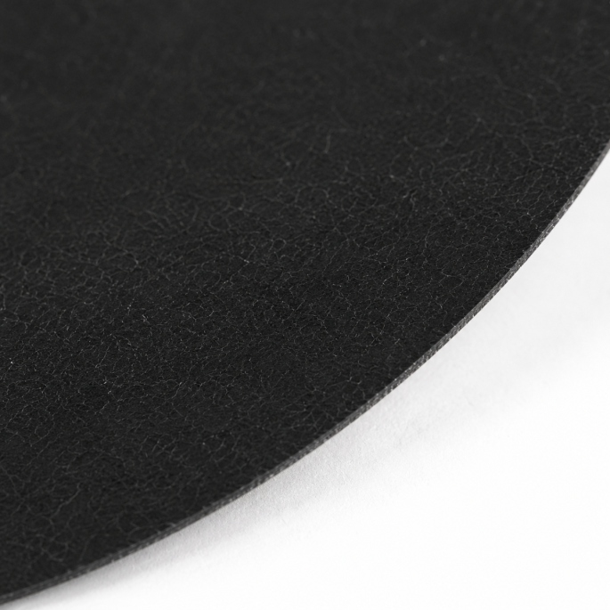 Extreme macro-opname van Meat Saver papier 65 g/m² rond zwart Ø 120 mm. De detailfoto toont de fijne papiervezels, matte oppervlaktestructuur en nauwkeurig gestanste rand van het absorberende verpakkingspapier voor vleesproducten.